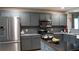 Bright kitchen with stainless steel fridge, microwave and views of the tile backsplash at 2206 Hunters Greene Dr, Lakeland, FL 33810