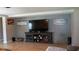 Living room with a large TV and modern console, plus colorful artwork on the walls at 2206 Hunters Greene Dr, Lakeland, FL 33810