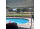Inviting screened-in pool area with a view of the serene lake in the backyard at 2206 Hunters Greene Dr, Lakeland, FL 33810