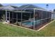 A screened-in pool is complimented by attractive decor and landscaping at 2206 Hunters Greene Dr, Lakeland, FL 33810