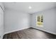 Bedroom featuring wood look floors, ample natural light, and a modern aesthetic at 225 Starling Ct, Kissimmee, FL 34759