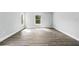 Bright and airy bedroom with wood-look flooring and large windows at 225 Starling Ct, Kissimmee, FL 34759