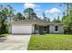 Charming single-story home with a manicured lawn and two car garage at 225 Starling Ct, Kissimmee, FL 34759