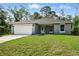 Charming single-story home with a manicured lawn and two car garage at 225 Starling Ct, Kissimmee, FL 34759