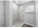 Bathroom showing new tiled shower with pebble floor and modern fixtures at 225 Starling Ct, Kissimmee, FL 34759