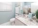 Light and bright bathroom featuring a granite vanity and a shower with beach-themed curtain at 2301 Butterfly Palm Way # 303, Kissimmee, FL 34747