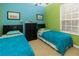 Colorful bedroom with twin beds, bright walls, and natural light at 2301 Butterfly Palm Way # 303, Kissimmee, FL 34747