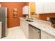 Modern kitchen features stainless steel appliances, granite countertops, and sleek white cabinets at 2301 Butterfly Palm Way # 303, Kissimmee, FL 34747