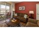 Comfortable living room offers a sliding door to a private balcony overlooking the neighborhood at 2301 Butterfly Palm Way # 303, Kissimmee, FL 34747
