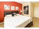 Bedroom with neutral linens, wall art, and bright wall colors at 2301 Butterfly Palm Way # 303, Kissimmee, FL 34747