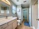 Bright bathroom featuring a large mirror, tiled floors, and access to a walk-in closet at 2408 Saint Augustine Blvd, Haines City, FL 33844