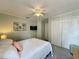 Cozy bedroom features TV, ceiling fan, closet, and soft natural light at 2408 Saint Augustine Blvd, Haines City, FL 33844