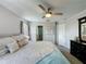 Bedroom features large bed, ceiling fan, and access to a walk-in closet and ensuite bathroom at 2408 Saint Augustine Blvd, Haines City, FL 33844