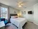 Serene bedroom featuring a comfortable bed, ceiling fan, and calming natural light at 2408 Saint Augustine Blvd, Haines City, FL 33844