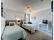 Bright bedroom featuring two twin beds, ceiling fan, and neutral color palette, offering a cozy and inviting atmosphere at 2408 Saint Augustine Blvd, Haines City, FL 33844