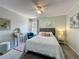 Bright bedroom with a comfortable bed, ceiling fan, vanity and natural light at 2408 Saint Augustine Blvd, Haines City, FL 33844