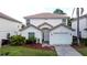 Charming two-story home featuring a well-maintained lawn, attached garage, and inviting facade for a welcoming curb appeal at 2408 Saint Augustine Blvd, Haines City, FL 33844