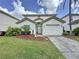 Charming two-story home with well-maintained lawn, landscaping, and a two-car garage at 2408 Saint Augustine Blvd, Haines City, FL 33844