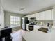 Bright kitchen featuring white cabinets, stainless steel appliances, and ample counter space at 2408 Saint Augustine Blvd, Haines City, FL 33844