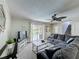 Cozy living room with plush seating, a ceiling fan, and sliding glass doors leading to the pool area at 2408 Saint Augustine Blvd, Haines City, FL 33844