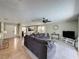 Open-concept living room with a large sectional sofa and view into the kitchen at 2408 Saint Augustine Blvd, Haines City, FL 33844