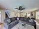 Inviting living room featuring a comfortable sectional sofa and modern ceiling fan at 2408 Saint Augustine Blvd, Haines City, FL 33844