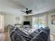 Spacious living room with a large sectional sofa and sliding glass doors that offer a view of the pool area at 2408 Saint Augustine Blvd, Haines City, FL 33844