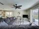 Inviting living room with a large sectional sofa, contemporary decor, and bright, natural light at 2408 Saint Augustine Blvd, Haines City, FL 33844