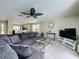 Comfortable living room featuring a large sectional sofa, modern decor, and an open layout at 2408 Saint Augustine Blvd, Haines City, FL 33844