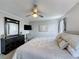 Elegant main bedroom with a king-size bed, dark wood dresser, ceiling fan, and soft lighting, creating a luxurious retreat at 2408 Saint Augustine Blvd, Haines City, FL 33844