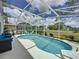 Inviting screened-in pool area with comfortable seating, perfect for relaxation and outdoor entertaining at 2408 Saint Augustine Blvd, Haines City, FL 33844