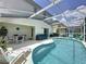 Sparkling pool with outdoor seating, perfect for relaxing and entertaining in the screened-in enclosure at 2408 Saint Augustine Blvd, Haines City, FL 33844