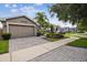 The home features a two car garage and paved driveway at 247 Bell Tower Xing W, Poinciana, FL 34759
