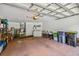 Spacious garage featuring laundry area, ample storage, and space for multiple vehicles at 247 Bell Tower Xing W, Poinciana, FL 34759