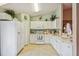 Functional kitchen with white cabinetry, appliances, and ample counter space at 247 Bell Tower Xing W, Poinciana, FL 34759