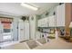 Well-lit kitchen with white appliances, ample counter space, and easy access to the outdoor patio at 247 Bell Tower Xing W, Poinciana, FL 34759