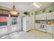 Bright kitchen features white appliances, tile flooring, and convenient access to the outdoors through glass doors at 247 Bell Tower Xing W, Poinciana, FL 34759