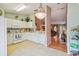 Charming kitchen with white cabinets and appliances adjacent to a living area, perfect for entertaining guests at 247 Bell Tower Xing W, Poinciana, FL 34759
