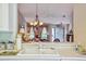 Open kitchen pass-through overlooks the living area, promoting connectivity and a spacious feel throughout the home at 247 Bell Tower Xing W, Poinciana, FL 34759