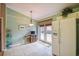 Eat-in kitchen area with tile floors, white refrigerator, and direct access to the outdoor patio at 247 Bell Tower Xing W, Poinciana, FL 34759