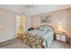Comfortable main bedroom featuring a ceiling fan, plush carpeting, and an ensuite bathroom at 247 Bell Tower Xing W, Poinciana, FL 34759