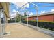 Expansive screened-in patio, perfect for outdoor enjoyment and entertaining, with views of the lush greenery at 247 Bell Tower Xing W, Poinciana, FL 34759
