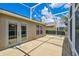 Spacious screened-in patio offering a relaxed outdoor living space with a view of the surrounding landscape at 247 Bell Tower Xing W, Poinciana, FL 34759