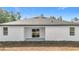 Rear of home, featuring a covered patio and sliding glass doors at 2639 Sw 162Nd Street Rd, Ocala, FL 34473