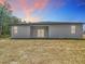 Exterior view of the rear of the home showing freshly graded lot and covered porch at 2639 Sw 162Nd Street Rd, Ocala, FL 34473