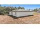 Exterior view of the rear of the home showing freshly graded lot and covered porch at 2639 Sw 162Nd Street Rd, Ocala, FL 34473