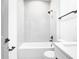 Clean, well-lit bathroom featuring white tub and tile surround, vanity, and modern fixtures at 2639 Sw 162Nd Street Rd, Ocala, FL 34473