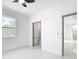 Bright bedroom showcasing tiled floors and views to both the bathroom and exterior at 2639 Sw 162Nd Street Rd, Ocala, FL 34473