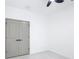 Neutral bedroom with gray closet doors, bright tiled floors, and a ceiling fan at 2639 Sw 162Nd Street Rd, Ocala, FL 34473