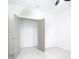 Bright bedroom featuring an open closet with gray doors and tiled flooring at 2639 Sw 162Nd Street Rd, Ocala, FL 34473